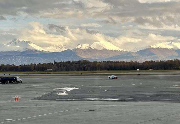 Photo from Anchorage airport looking east to the Chugach Mountains, which are partially illuminated in the late afternoon sunshine. Photo taken Oct 12, 2026.