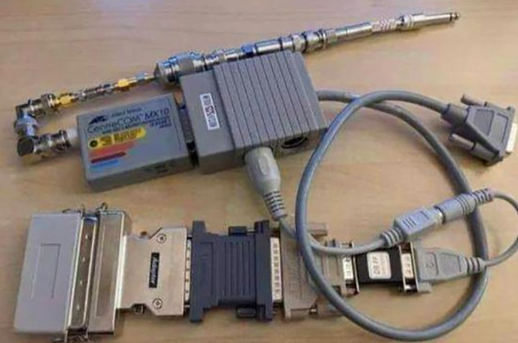 A poor quality photo of a chain of about 10 different adaptors converting what seems to be a serial port to a TR jack.